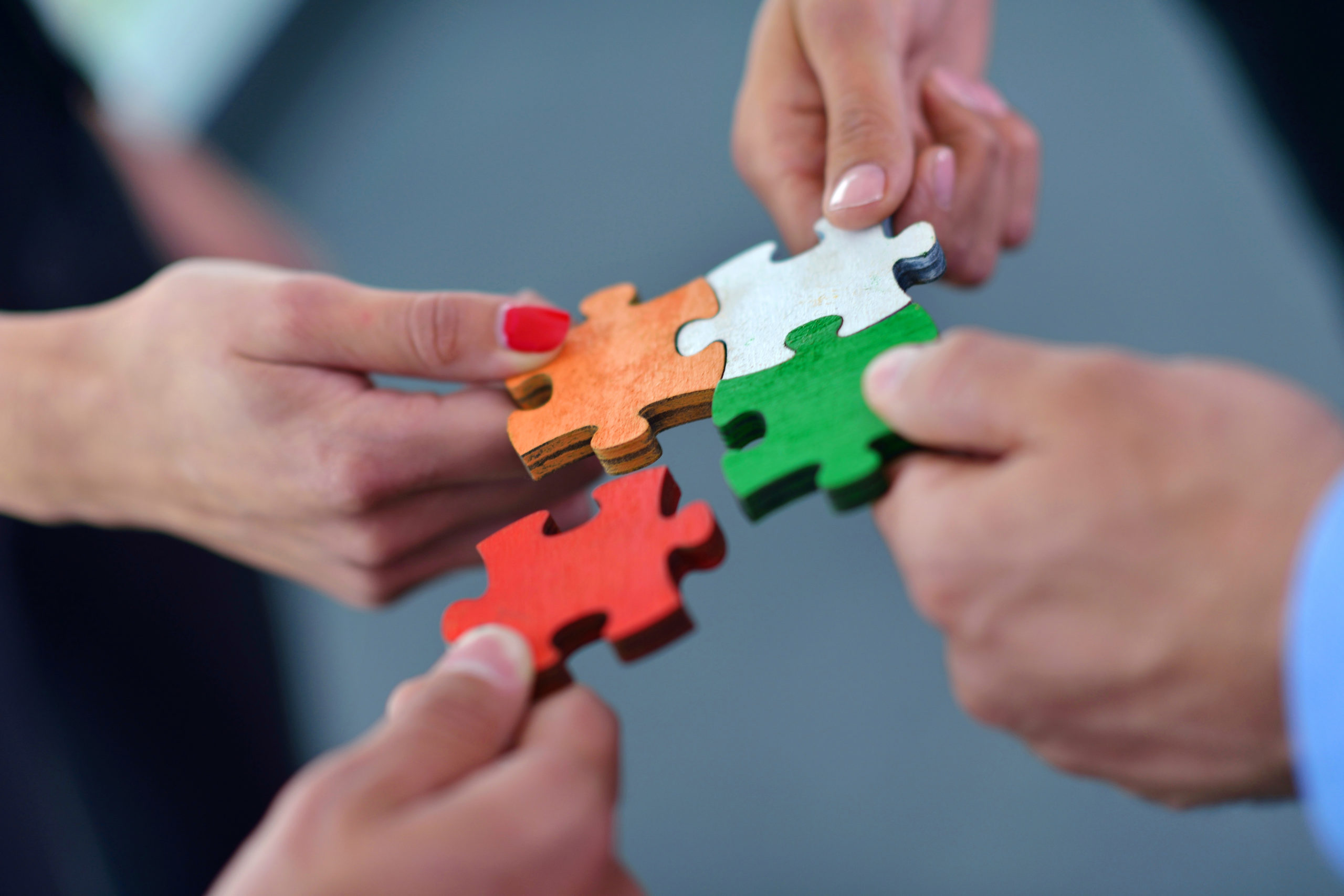 Group,Of,Business,People,Assembling,Jigsaw,Puzzle,And,Represent,Team